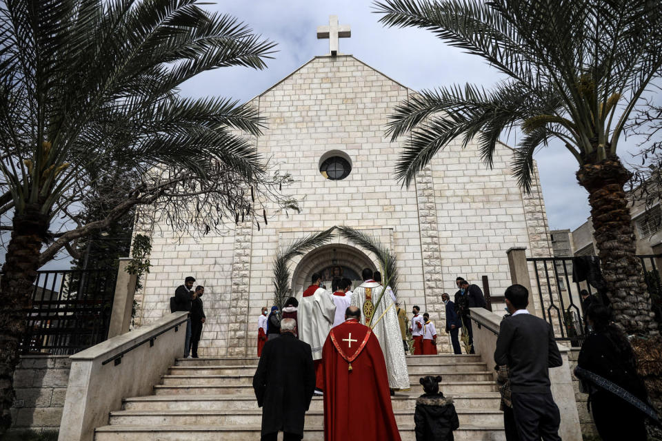 Palestinian Christians arrive to attend the Palm Sunday mass at the Holy Family  Catholic church in Gaza City, on March 28, 2021. (Mohammed Abed / AFP via Getty Images)