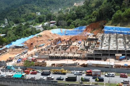 Rescue workers are seen at a construction site after it was hit by a landslide in Tanjung Bungah, Penang, Malaysia October 21, 2017. REUTERS/Stringer