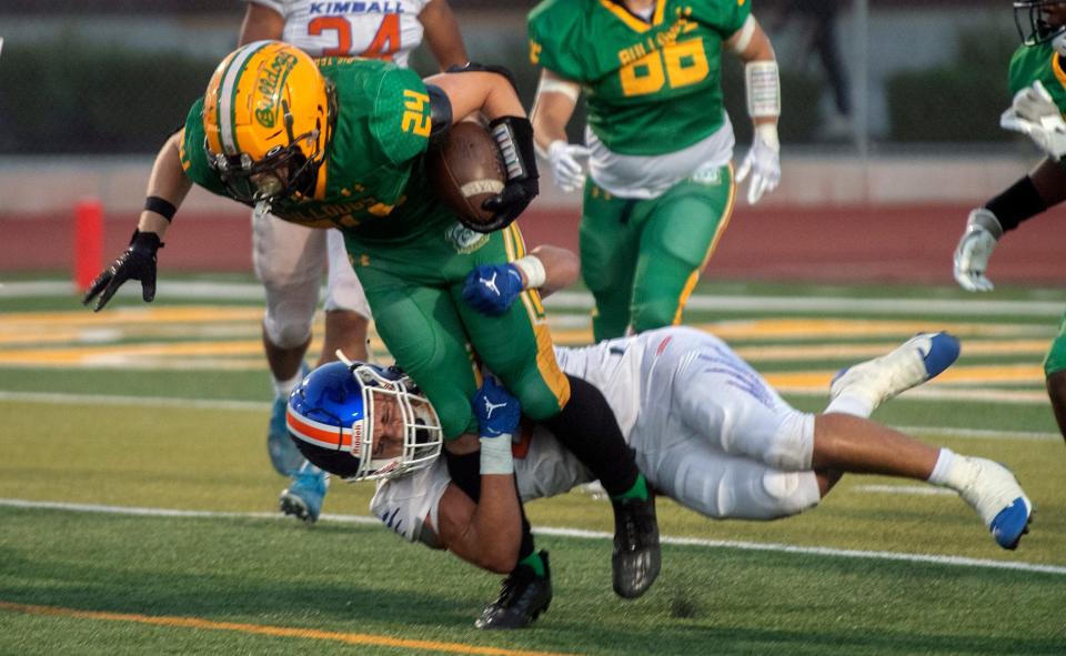 Tracy's Tommy Hayes, top, is tackled by Kimball's Junior Saaverda during a varsity football game at Tracy's Wayne Schneider Stadium in Tracy.