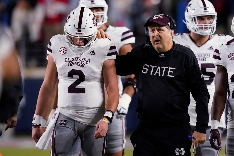 Mississippi State coach Mike Leach confers with quarterback Will Rogers during a game against Mississippi on Nov. 24.