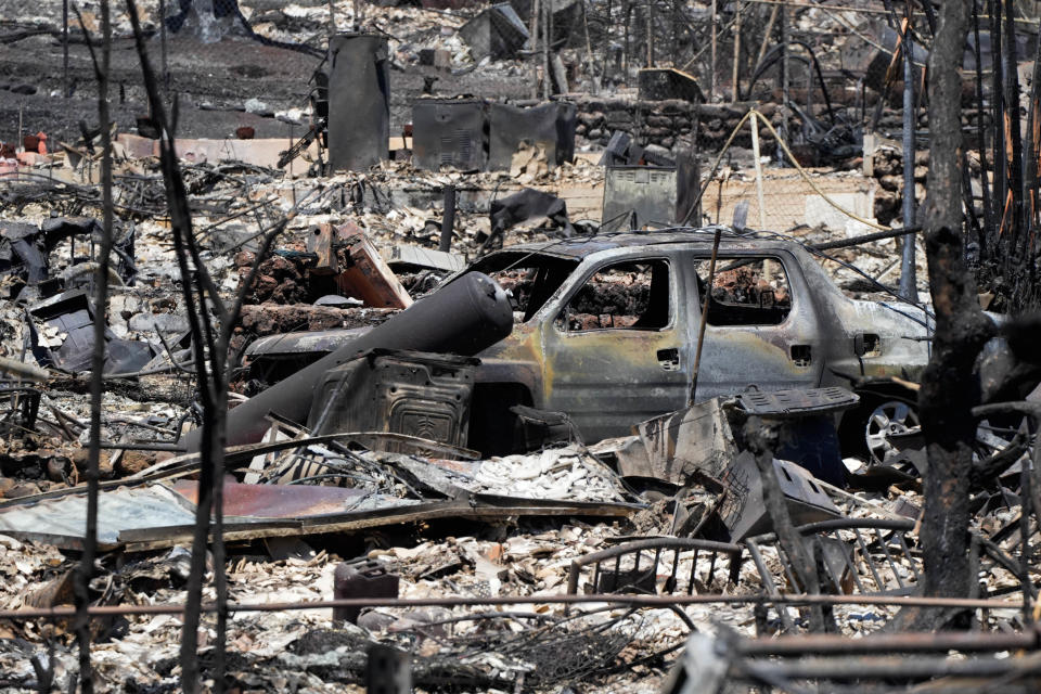 In this file photo, burned cars and buildings are seen from Honoapiilani Highway that runs through the heart of Lahaina, Hawaii, Aug. 13. Thousands were displaced after a wildfire fueled by winds from Hurricane Dora and dry vegetation destroyed much of the town. The death toll from the fire makes it the deadliest wildfire of the past U.S. century.