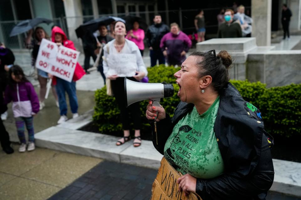 Abortion rights activist Amy Nachtrab, of Delaware, Ohio, protests in support of abortion rights near the Supreme Court of Ohio. The protest comes a day after a U.S. Supreme Court draft decision overturning Roe v. Wade was leaked. The 1973 landmark ruling protects a woman's right to choose to have an abortion. About 75 people stood outside protesting as heavy rail fell, which grew to about 150 within an hour. 