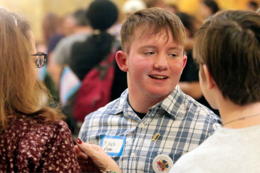 Mack Allen, of Leavenworth, Kan., speaks with friends and family following a rally for LGBTQ youth at the Statehouse, Wednesday, Jan. 31, 2024, in Topeka, Kan. Allen, 18, is transgender, and he says he’s been challenged when he’s been forced to use women’s restrooms in public spaces. (AP Photo/John Hanna)