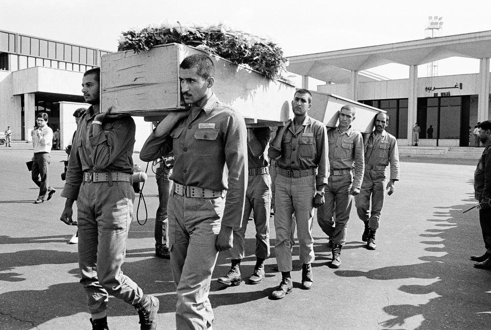 FILE - In this July 12, 1988 file photo, a funeral procession is held for six Pakistani and Indian nationals who were killed aboard Iran Air Flight 655, July 12, 1988, in Iran. The Western allegation that Iran shot down a Ukrainian jetliner and killed 176 people offers a grim echo for the Islamic Republic, which found itself the victim of an accidental shootdown by American forces over 30 years ago. (AP Photo, File)