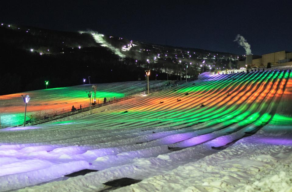 Snow tubing lanes are lit up at night at the Camelback Resort in the Poconos