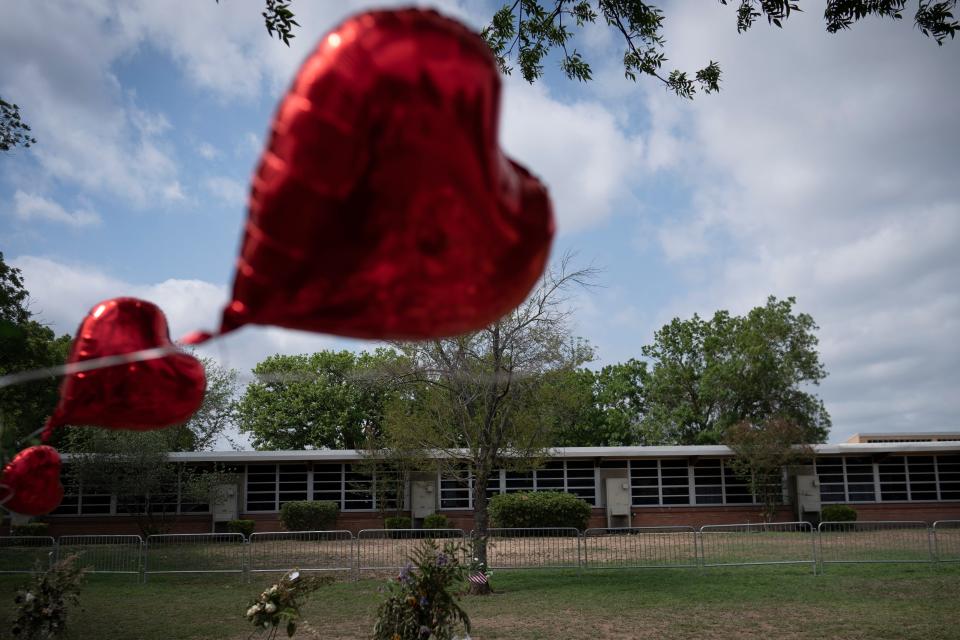 A heart-shaped balloon flies outside Robb Elementary School in Uvalde, Texas, on May 30, 2022.