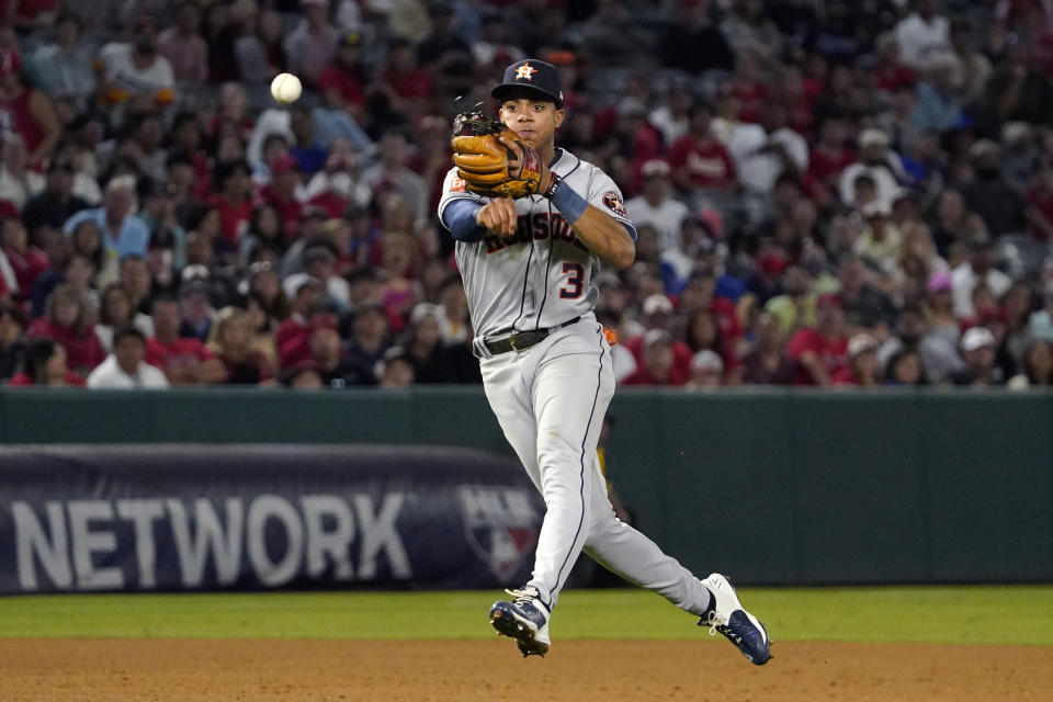 Houston Astros shortstop Jeremy Pena attempts to throw out Los Angeles Angels' Jonathan Villar at first during the sixth inning of a baseball game Wednesday, July 13, 2022, in Anaheim, Calif. The throw was off target and Villar advanced to second on the play. (AP Photo/Mark J. Terrill)