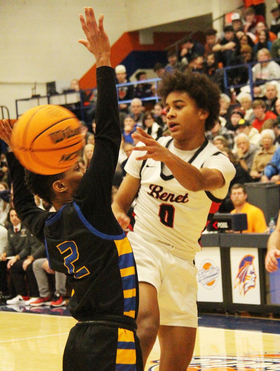 Brayden Fagbemi of Benet tosses a pass around Simeon defender Jalen Griffith in Friday's championship game of the 91st Pontiac Holiday Tournament. Griffith led Simeon to the title with a game-high 17 points.