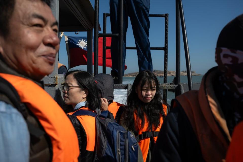 Mao You-lun (毛佑倫, 20), middle, and her mother (my cousin), left, aboard the military transport after voting for the first time on Jan. 13. Residents had a total of 45 minutes on the island to cast their ballots. Chairperson of Township Council Chen Xing-de stands on the left.<span class="copyright">Mike Kai Chen for TIME</span>