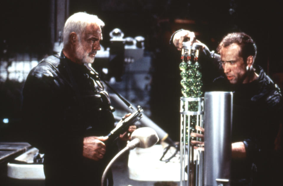 Sean Connery and Nicolas Cage look at green vials