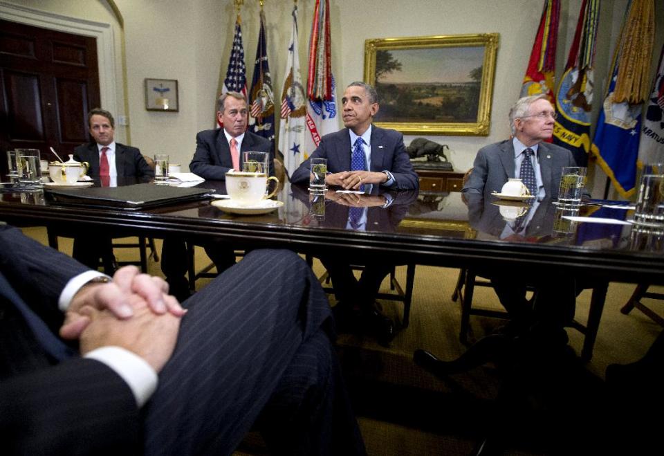 President Barack Obama pauses as he hosts a meeting of the bipartisan, bicameral leadership of Congress to discuss the deficit and economy, Friday, Nov. 16, 2012, in the Roosevelt Room of the White House in Washington. From left are, Treasury Secretary Timothy Geithner, House Speaker John Boehner of Ohio, the president, and Senate Majority Leader Harry Reid of Nev. (AP Photo/Carolyn Kaster)