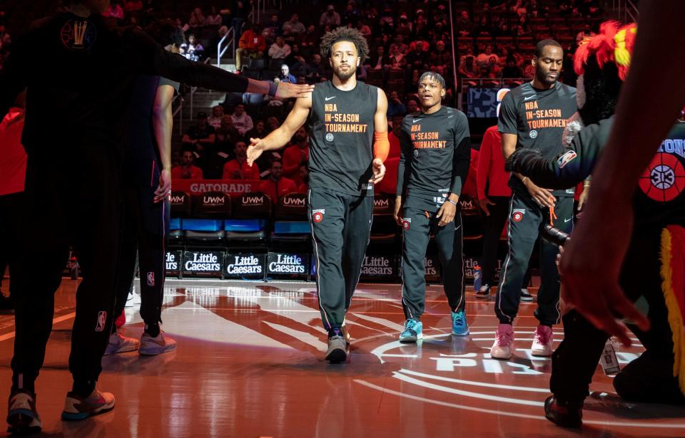 Pistons guard Cade Cunningham low-fives his teammates before the start of the game against the Hawks at Little Caesars Arena in Detroit on Tuesday, Nov 14, 2023.