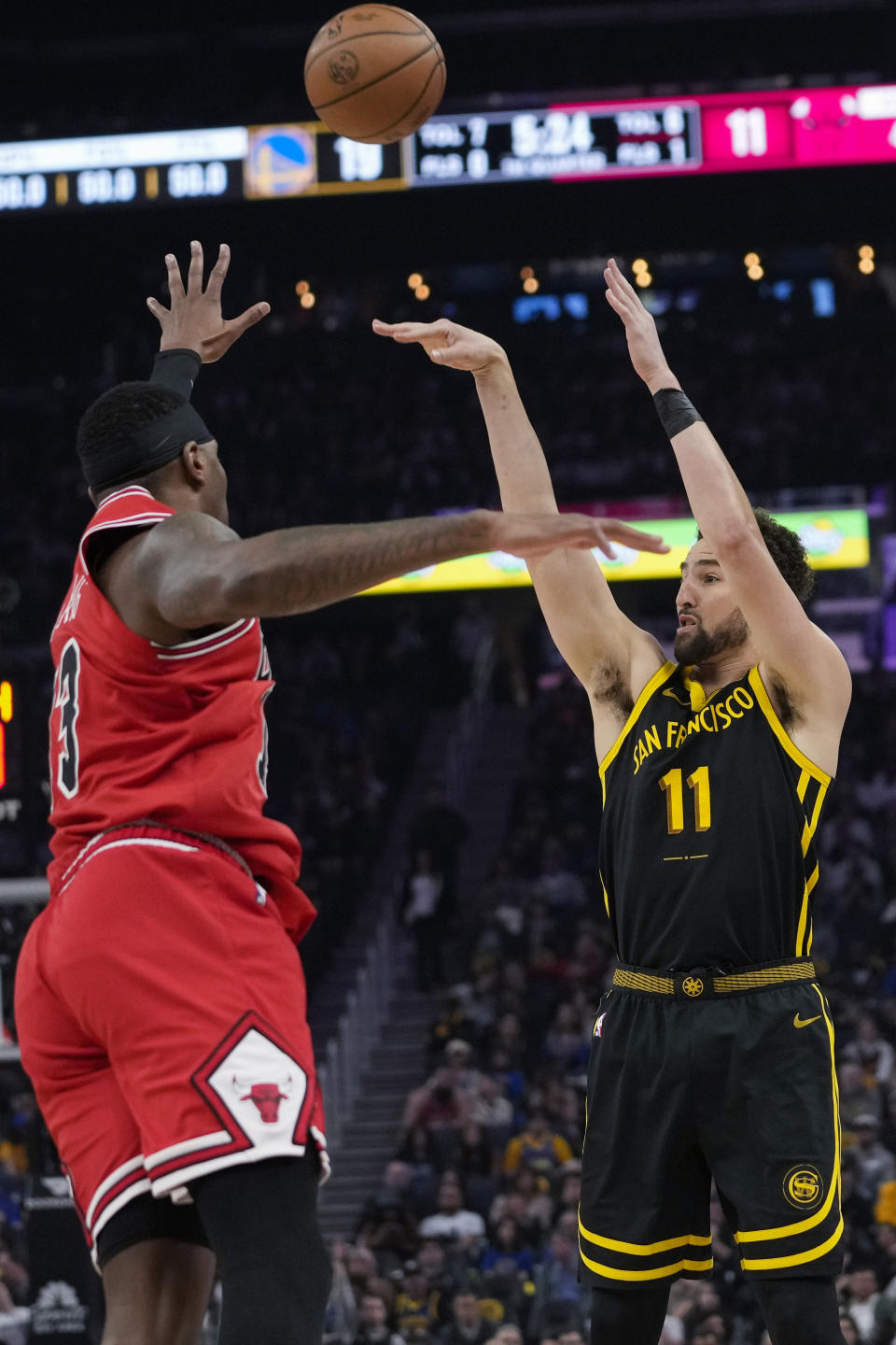 Golden State Warriors guard Klay Thompson shoots a 3-point basket over Chicago Bulls forward Torrey Craig during the first half of an NBA basketball game Thursday, March 7, 2024, in San Francisco. (AP Photo/Godofredo A. Vásquez)