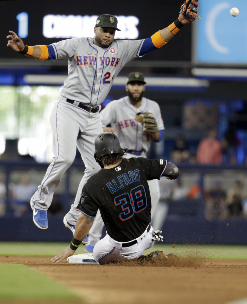 Miami Marlins' Jorge Alfaro (38) beats the throw to New York Mets second baseman Robinson Cano (24) to steal second in the fourth inning during a baseball game, Saturday, May 18, 2019, in Miami. (AP Photo/Lynne Sladky)