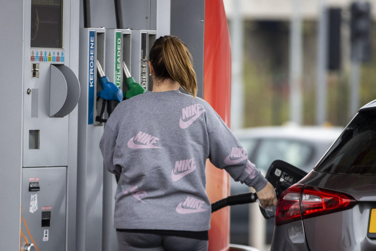 A woman at GO Petrol Station in Belfast, as petrol prices soar