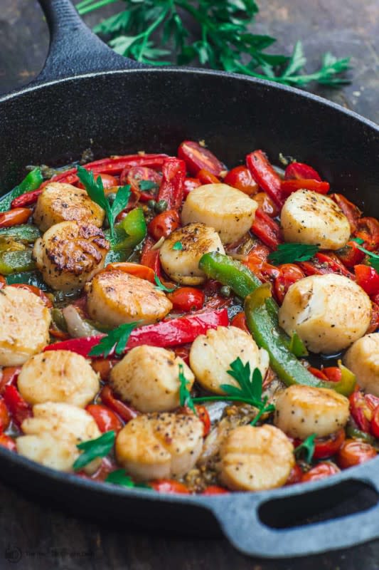 <p>The Mediterranean Dish</p><p>Easy, quick-seared buttery scallops, nestled in a flavor-packed mixture of tomatoes and bell peppers! You’ll love the bold Mediterranean flavors in this scallops recipe–fresh garlic, shallots, capers, oregano and more.</p><p><strong>Get the recipe: <a href="https://www.themediterraneandish.com/easy-scallops-recipe/" rel="nofollow noopener" target="_blank" data-ylk="slk:Easy Mediterranean-Style Scallops;elm:context_link;itc:0;sec:content-canvas" class="link rapid-noclick-resp">Easy Mediterranean-Style Scallops</a></strong></p>
