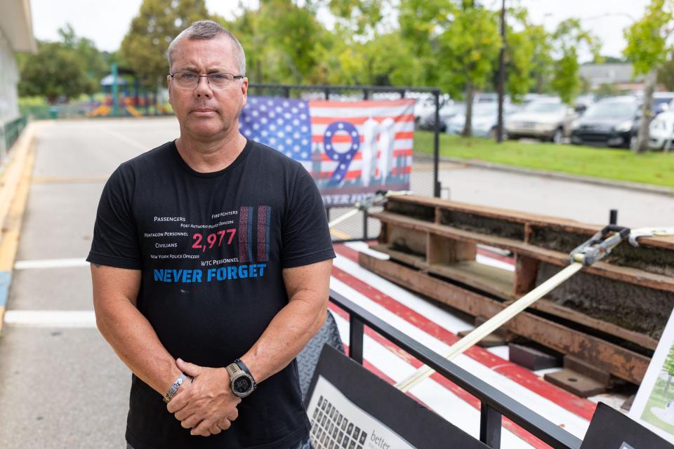 Michael Terhune, a retired Tallahassee Fire Department firefighter, stands next to a beam from the twin towers that he brought to share with students at Roberts Elementary School as a way to teach them about the history of 9/11 on Friday, Sept. 9, 2022. 