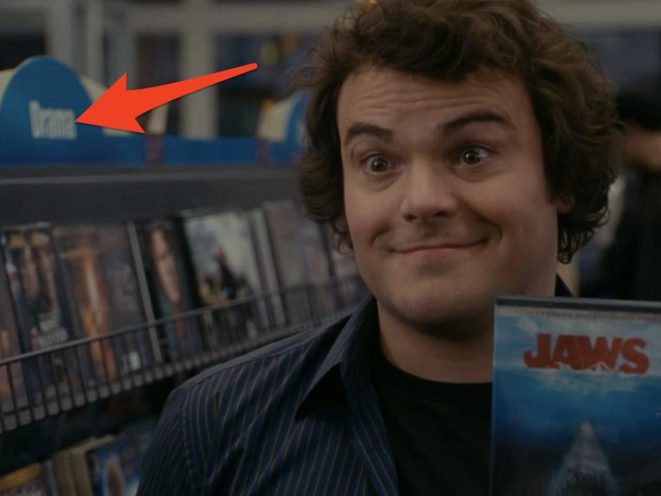 miles holding a copy of jaws in a video store in the holiday
