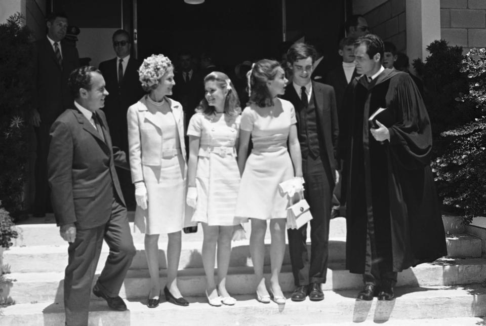 President Richard Nixon, left, poses with Rev. John Huffman, Jr., right, after attending Easter services with his family at the Key Biscayne Presbyterian Church, April 6, 1969. With the president is first lady Pat Nixon, second from left, and daughters Tricia and Julie Nixon Eisenhower, center, and Julie's husband, David, second from left. David Eisenhower called his in-laws Mr. and Mrs. Nixon.