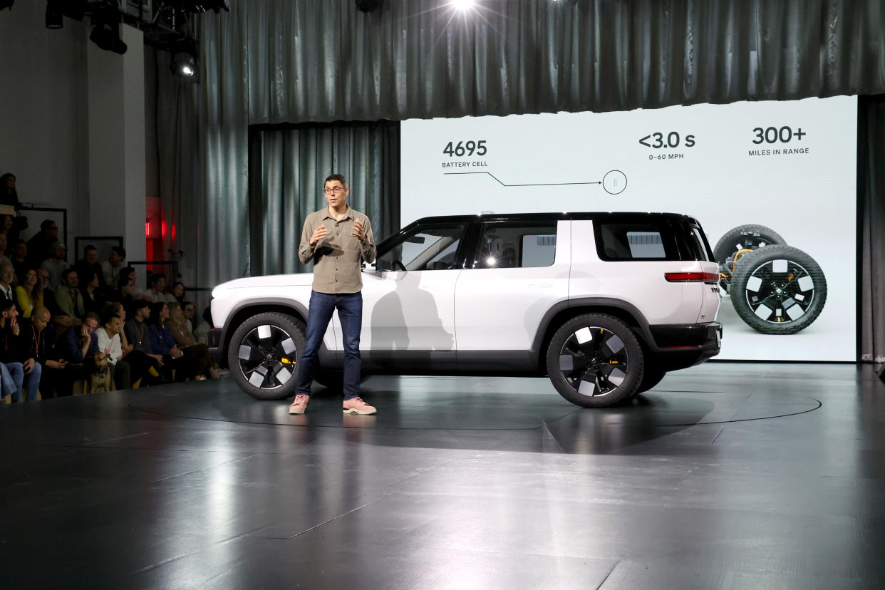 LAGUNA BEACH, CALIFORNIA - MARCH 07: Founder and CEO of Rivian RJ Scaringe speaks onstage during the Rivian Reveals All-Electric R2 Midsize SUV event at Rivian South Coast Theater on March 07, 2024 in Laguna Beach, California. (Photo by Phillip Faraone/Getty Images for Rivian)