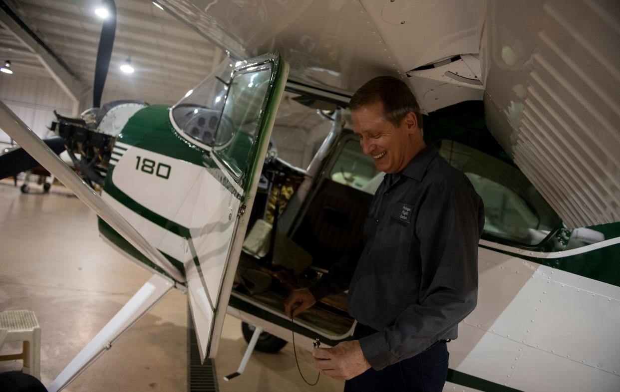 Matt Showalter, Portage Flight Center aircraft mechanic, holds a cable from working on a 1953 Cessna 180 at the Portage County Regional Airport. Consultants hired by the Portage County Commissioners are visiting to tour the airport and help determine the next steps in a possible county takeover of the site.