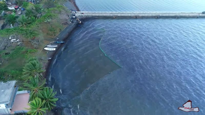 A general view shows the leaked oil from the bulk carrier ship MV Wakashio, after it ran aground on a reef, at Bois des Amourettes