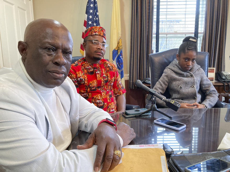 From left, Prince Dwumfour, Peter Ezechukwu and Nicole Teliano take part in an interview at their lawyer's office in Sayreville, N.J., April 5, 2023. Their family member, Eunice Dwumfour, a Sayreville council member, was fatally shot Feb. 1 as she arrived home in Sayreville. (AP Photo/Michael Rubinkam)