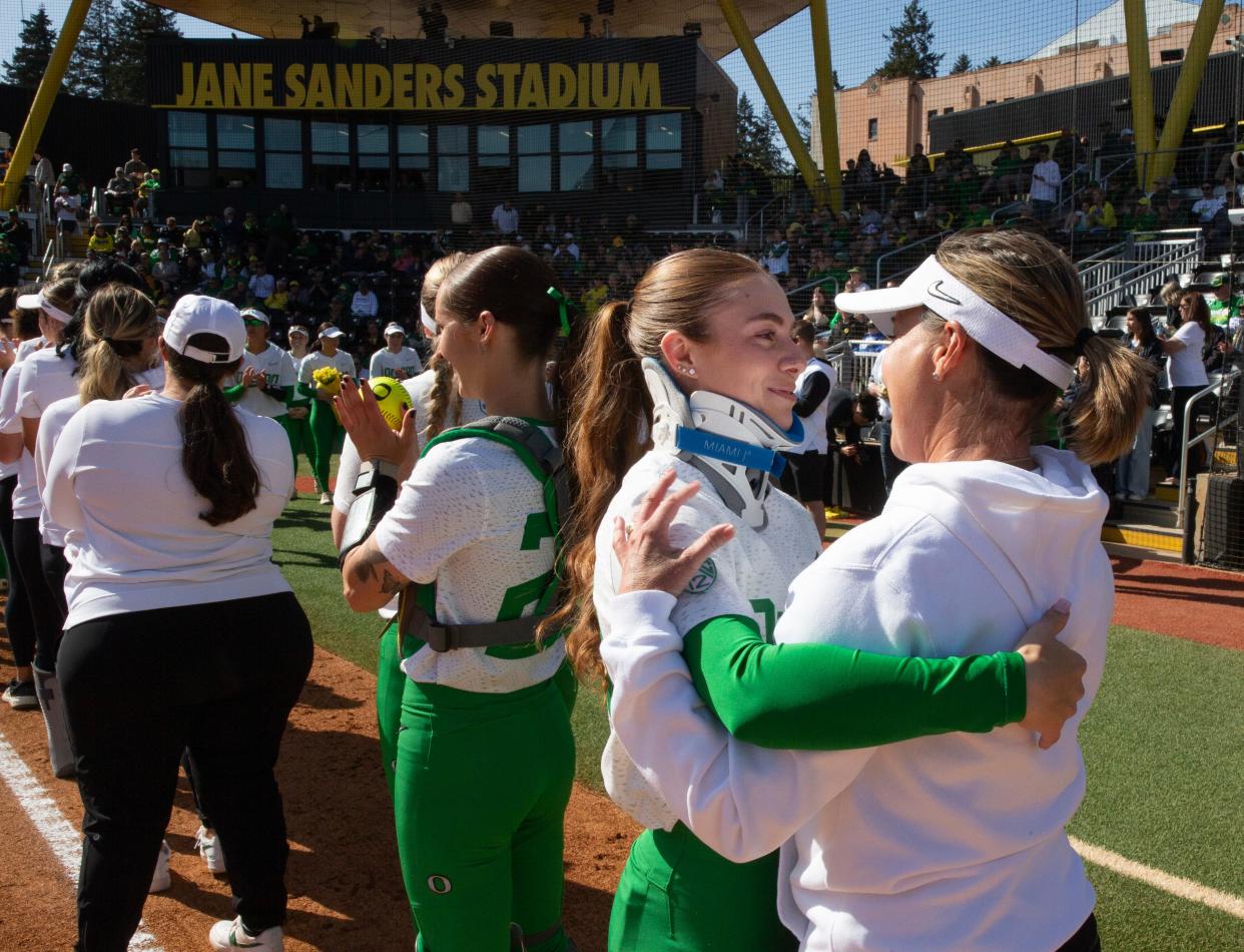 Oregon’s Hanna Delgado, left, in a neck brace gives coach Melyssa Lombardi a hug before the game against Oregon State at Jane Sanders Stadium Sunday, April 21, 2024