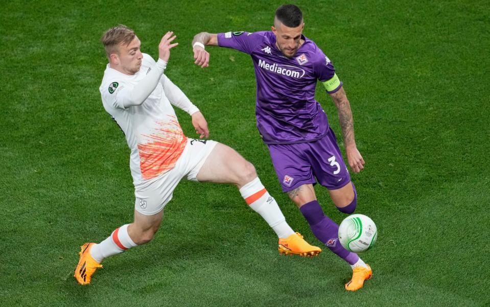 West Ham's Jarrod Bowen, left, challenges for the ball with Fiorentina's Cristiano Biraghi during the Europa Conference League final soccer match between Fiorentina and West Ham - AP Photo/Darko Vojinovic