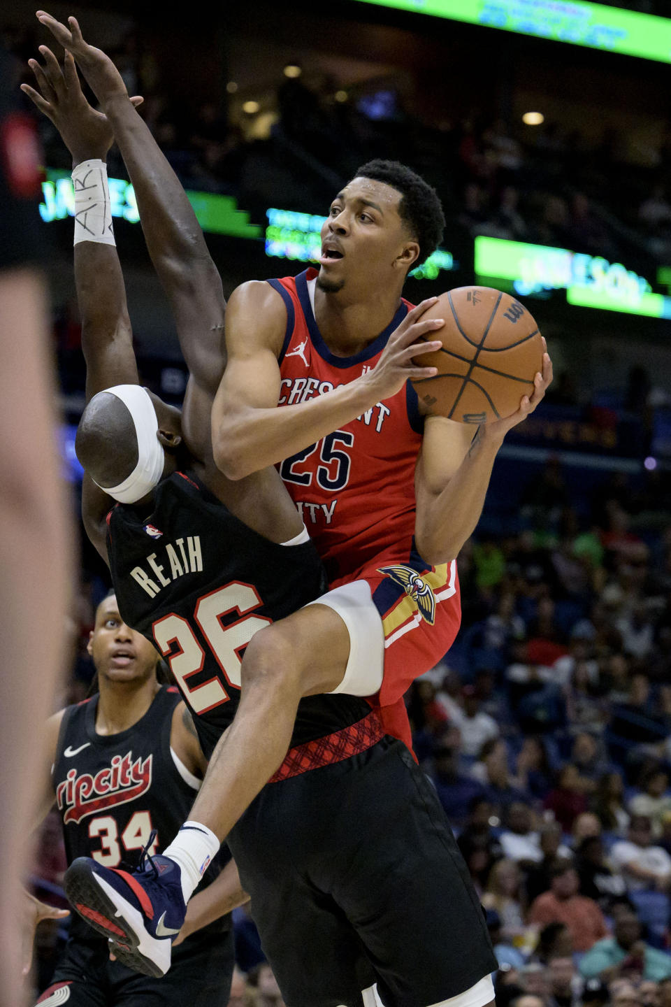 New Orleans Pelicans guard Trey Murphy III (25) shoots against Portland Trail Blazers center Duop Reath (26) during the first half of an NBA basketball game in New Orleans, Saturday, March 16, 2024. (AP Photo/Matthew Hinton)