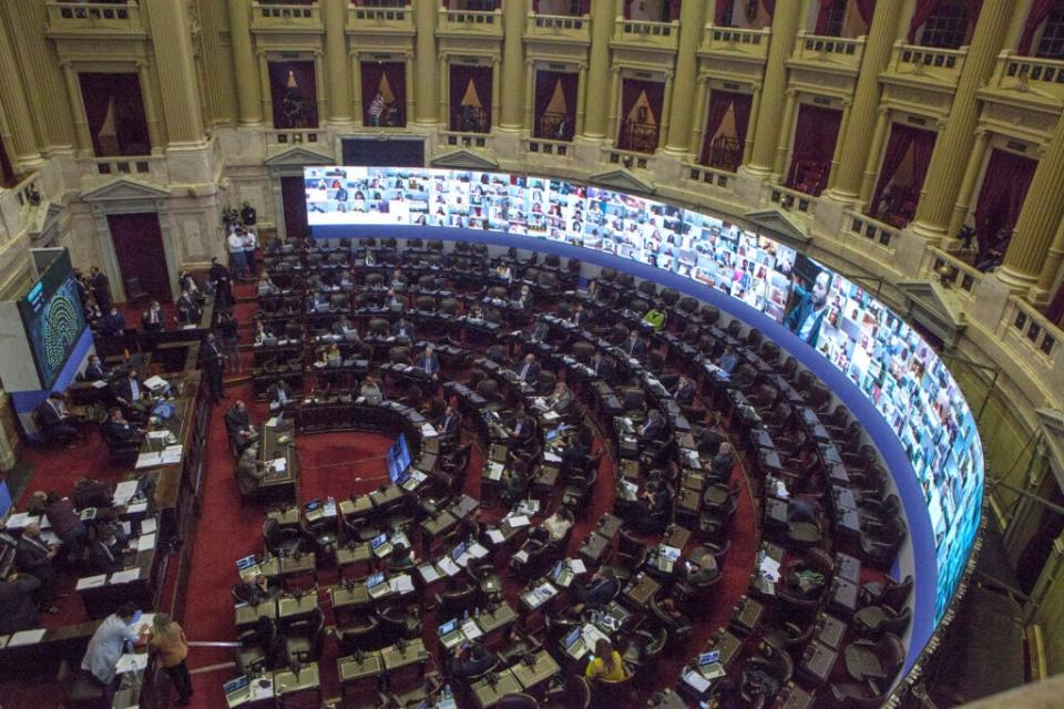 Screens show the faces of deputies who participate remotely of a session during the lockdown to curb spread of COVID-19 at Argentina National Congress on May 13, 2020 in Buenos Aires, Argentina. (Photo by Ricardo Ceppi/Getty Images)