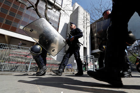 French police walk in front of the entrance of the Tolbiac university site, branch of Paris 1 university, after the evacuation of around 100 people who had occupied the university premises in protest against student admissions rules, in Paris, France, April 20, 2018. REUTERS/Gonzalo Fuentes