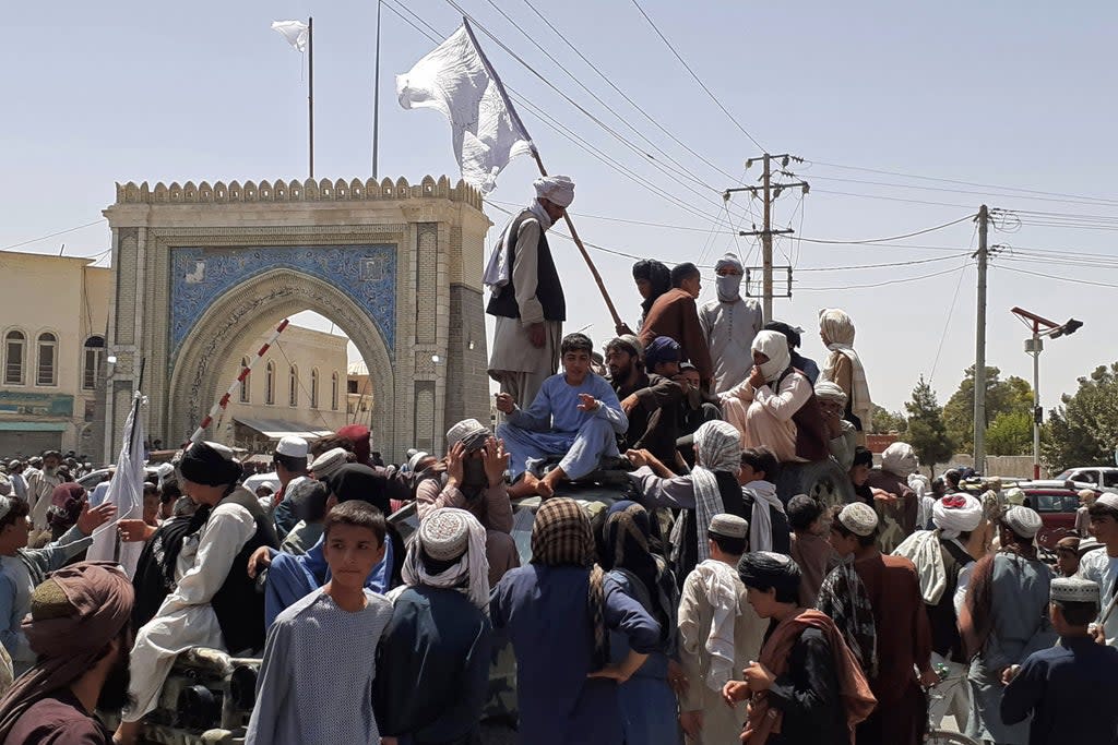 File: Taliban fighters stand on a vehicle along the roadside in Kandahar on 13 August 2021 (AFP via Getty Images)