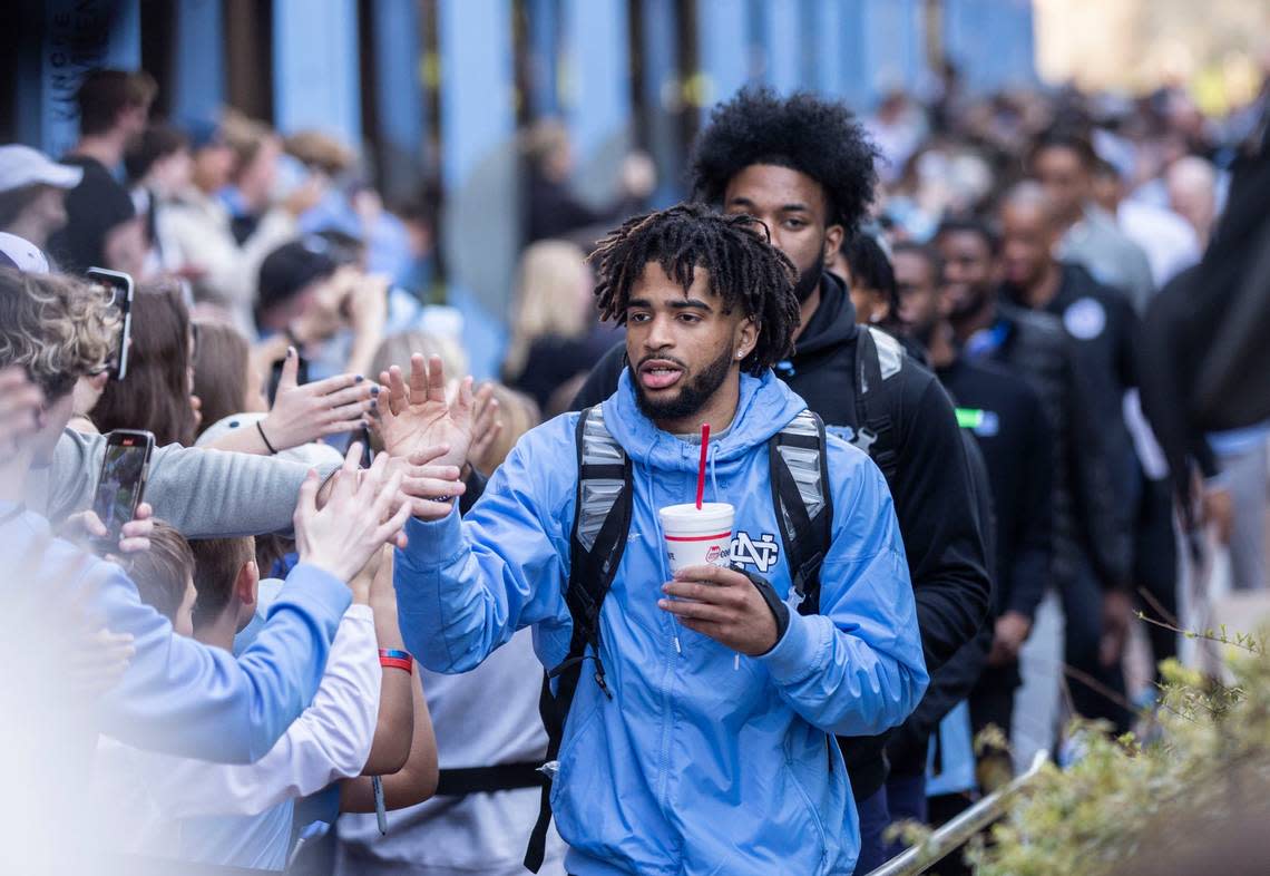RJ Davis high-fives fans as the UNC mens basketball team walks towards their bus outside the Dean Dome in Chapel Hill, N.C. to make their way to New Orleans for the Final Four on Wednesday, March 30, 2022.