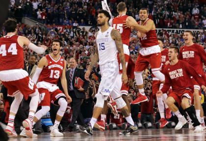 Wisconsin bench celebrates as Kentucky&#39;s Willie Cauley-Stein walks off after the loss. (AP)