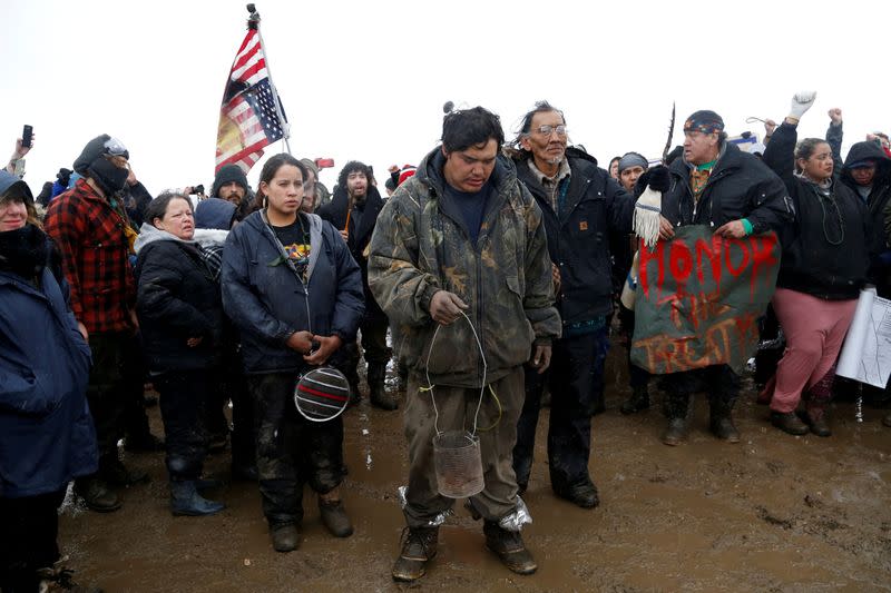 FILE PHOTO: Nathan Phillips prays with other protesters near the main opposition camp against the Dakota Access oil pipeline near Cannon Ball