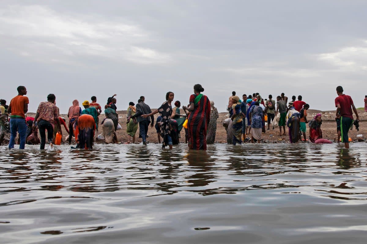 Ethiopian migrants pictured in 2019 at the shores of Ras al-Ara (AP)