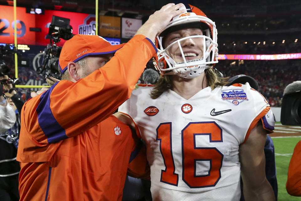 Clemson quarterback Trevor Lawrence (16) is congratulated after Clemson defeated Ohio State 29-23 in the Fiesta Bowl NCAA college football playoff semifinal Saturday, Dec. 28, 2019, in Glendale, Ariz. (AP Photo/Ross D. Franklin)