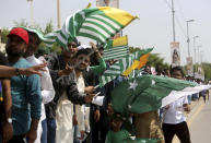 Pakistani cricket fans wave Kashmiri flags to express solidarity with Indian Kashmiris, as they wait to enter the National stadium in Karachi, Pakistan, Monday, Sept. 30, 2019. Karachi's 10-year long wait to host a one-day international finally ended on Monday as Pakistan won the toss and elected to bat against Sri Lanka in the second ODI. (AP Photo/Fareed Khan)