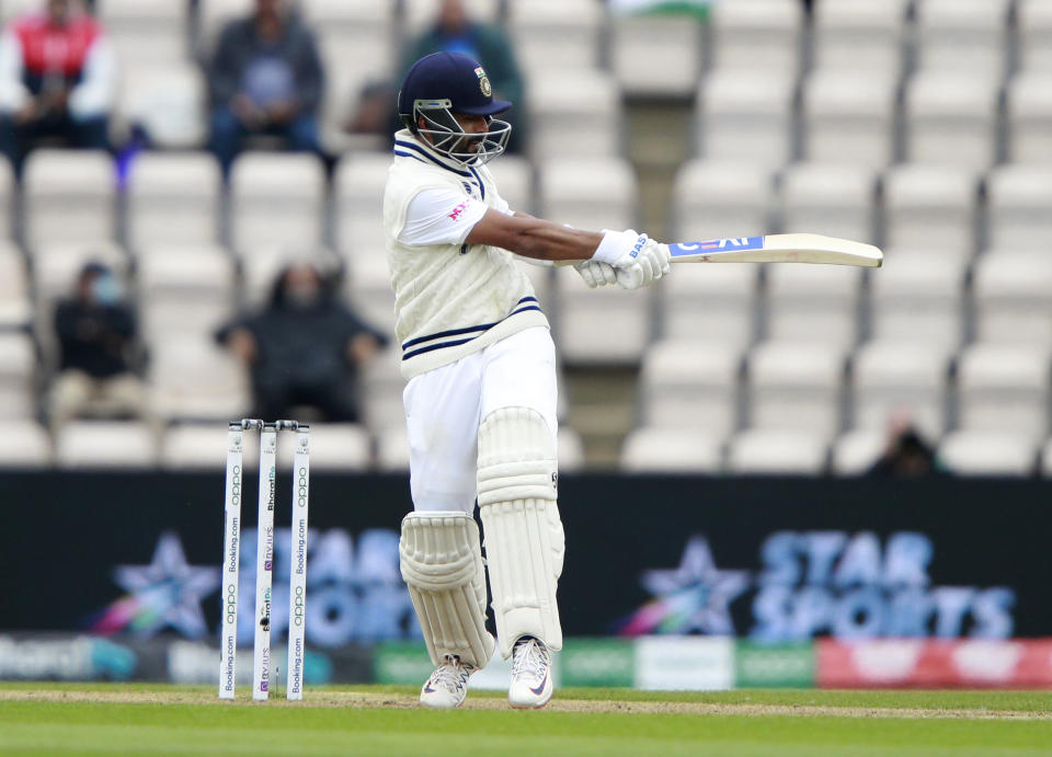 India's Ajinkya Rahane hits a boundary during the second day of the World Test Championship final cricket match between New Zealand and India, at the Rose Bowl in Southampton, England, Saturday, June 19, 2021. (AP Photo/Ian Walton)