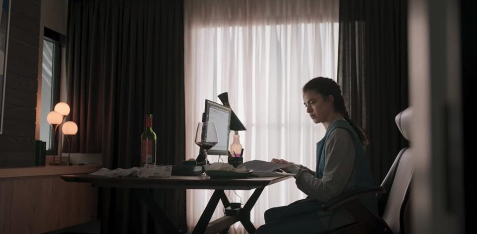 Alex sits in front of Regina's computer in secret