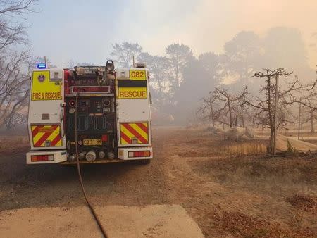 A fire engine is pareked near a bushfire in New South Wales, Australia, August 15, 2018, in this picture obtained from social media. Fire and Rescue NSW/via REUTERS