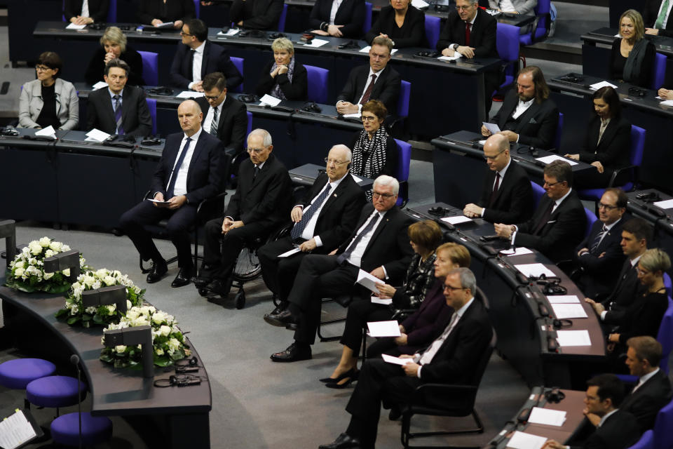 First row from left: President of German Bundesrat Dietmar Woidke, Parliament President Wolfgang Schaeuble, Israel's President Reuven Rivlin, German President Frank-Walter Steinmeier and his wife Elke Buedenbender, German Chancellor Angela Merkel and the President of Federal Constitutional Court Andreas Voßkuhle attend a special meeting of the German Parliament Bundestag commemorating the victims of the Holocaust in Berlin, Germany, Wednesday, Jan. 29, 2020. (AP Photo/Markus Schreiber)