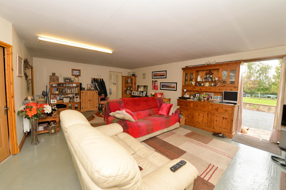 The living room is concealed behind the double garage doors (SWNS.com)