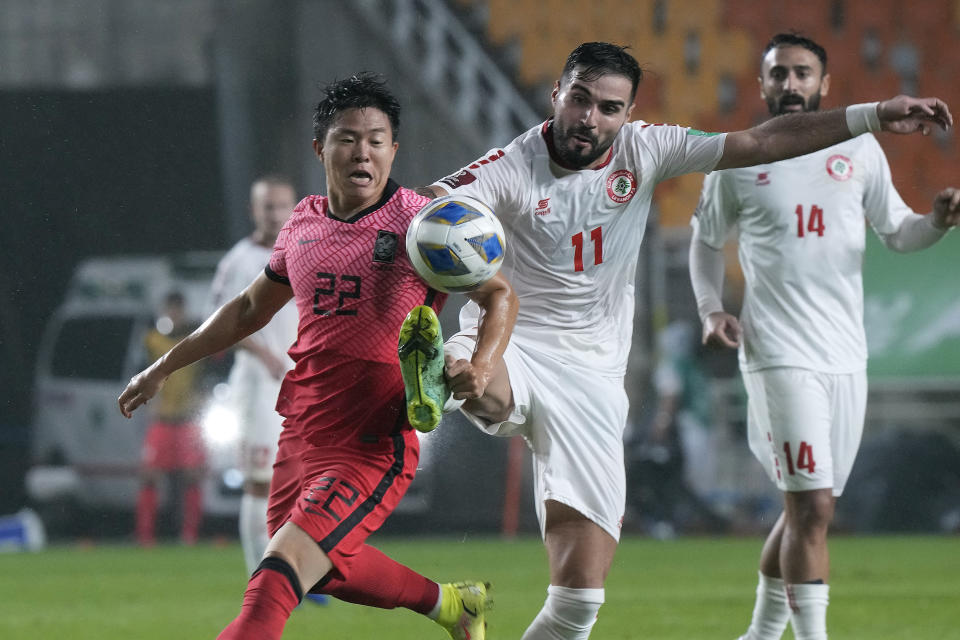 South Korea's Kwon Chang-hoon, left, fights for the ball with Lebanon's Hassan Saad during the final round of the Asian zone group A qualifying soccer match for the World Cup Qatar 2022 at Suwon World Cup stadium in Suwon, South Korea, Tuesday, Sept. 7, 2021. (AP Photo/Ahn Young-joon)