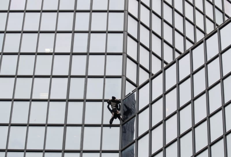 French Spiderman climbs Total tower in support of pensions strikers at La Defense