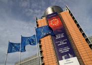 FILE PHOTO: European Union flags fly outside the European Commission headquarters in Brussels