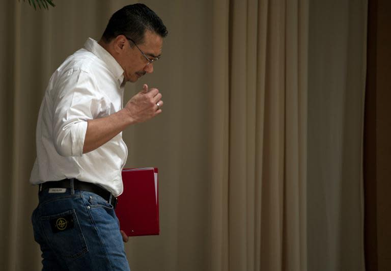 Malaysian Minister of Defence and Acting Transport Minister Hishammuddin Hussein leaves after speaking at a press conference at a hotel in Kuala Lumpur on April 19, 2014