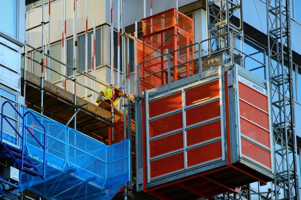 Workmen remove the cladding from the facade of a block of flats in Paddington, north London (Aaron Chown/PA) (PA Archive)