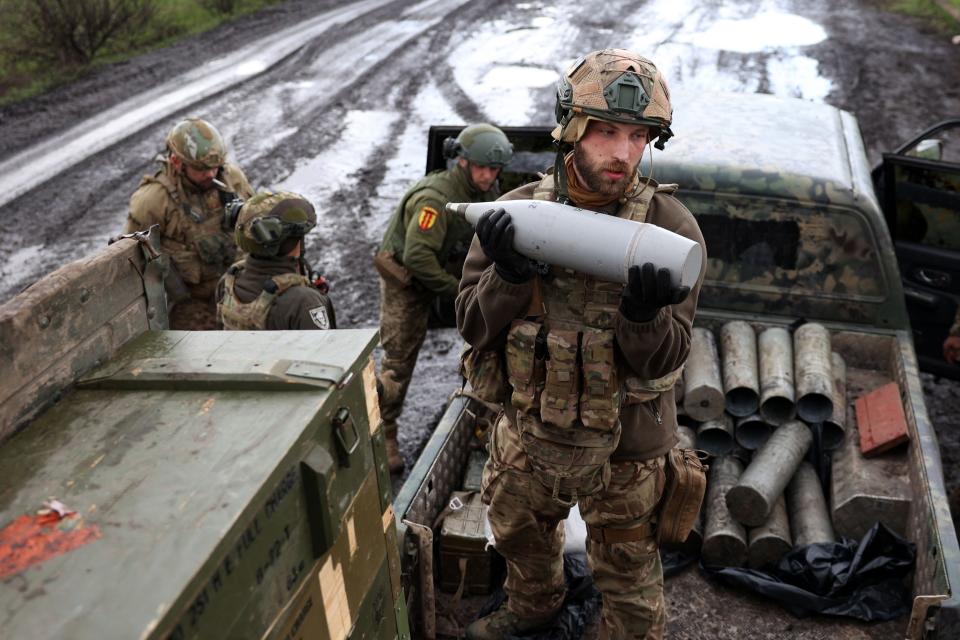 A Ukrainian artilleryman holds an artillery shell on a front line position near Bakhmut, Donetsk region, on April 22, 2023.